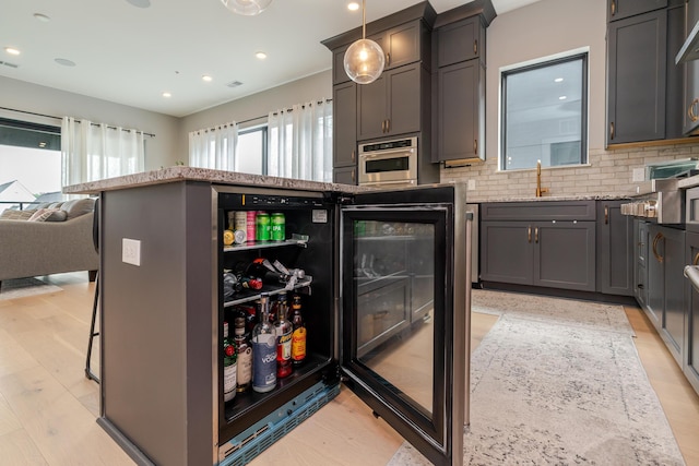 2891 Kobuk Dr Unit 301, Columbus, OH 43228 - kitchen featuring stainless steel oven, light stone counters, light wood finished floors, recessed lighting, and backsplash