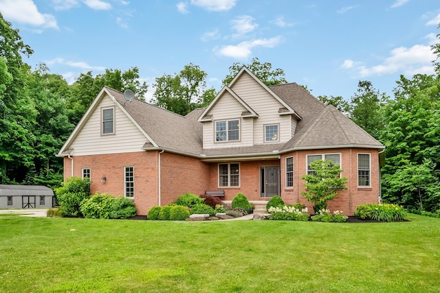 1554 Hanover Rd, Delaware, OH 43015 - view of front of home featuring brick siding, a front yard, and roof with shingles