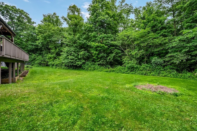 1554 Hanover Rd, Delaware, OH 43015 - view of green lawn featuring a wooden deck and a view of trees