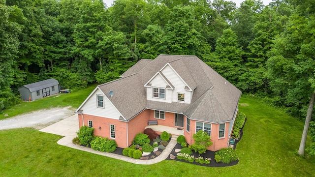 1554 Hanover Rd, Delaware, OH 43015 - view of front of property with driveway, brick siding, a front yard, a wooded view, and a shingled roof