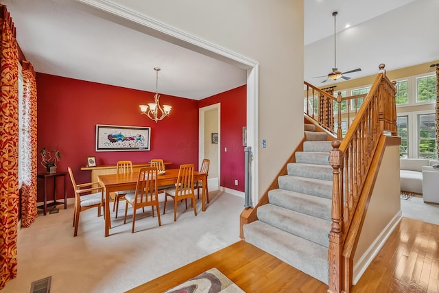 1554 Hanover Rd, Delaware, OH 43015 - dining area with stairway, a chandelier, wood finished floors, ceiling fan, and an accent wall