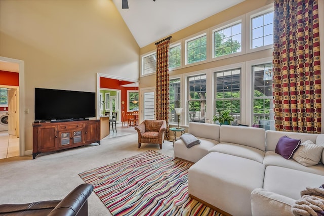 1554 Hanover Rd, Delaware, OH 43015 - living area featuring high vaulted ceiling, washer / dryer, light colored carpet, plenty of natural light, and a ceiling fan