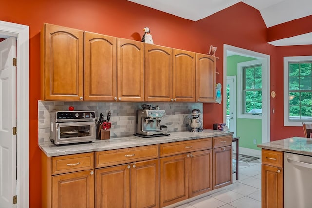 1554 Hanover Rd, Delaware, OH 43015 - kitchen featuring stainless steel dishwasher, tasteful backsplash, light stone countertops, and brown cabinets