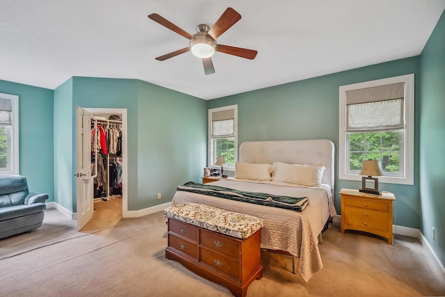 1554 Hanover Rd, Delaware, OH 43015 - bedroom featuring light colored carpet, a walk in closet, a closet, and a ceiling fan
