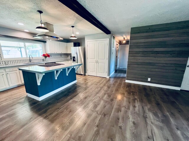 332 Baroness Way, Columbus, OH 43230 - kitchen featuring stainless steel appliances, a textured ceiling, wall chimney range hood, backsplash, and dark wood finished floors