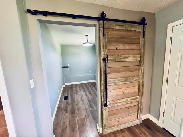 332 Baroness Way, Columbus, OH 43230 - corridor featuring a barn door and dark wood-style flooring