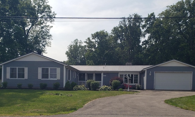 9840 Buckeye Dr, Huntsville, OH 43324 - ranch-style house with asphalt driveway, a garage, a front yard, a metal roof, and a chimney