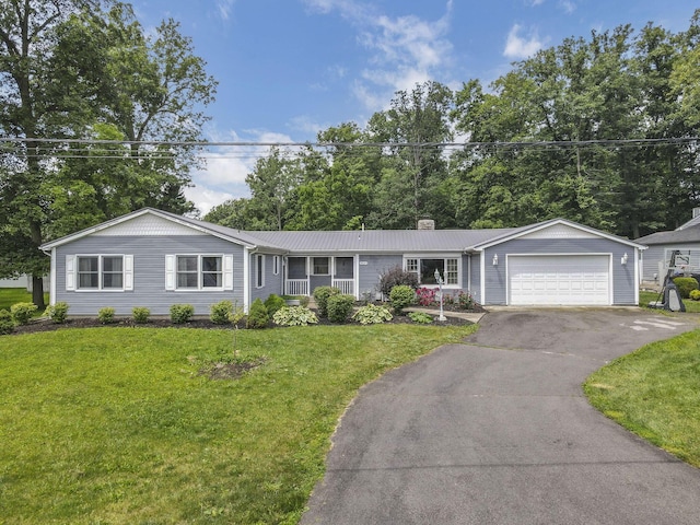 9840 Buckeye Dr, Huntsville, OH 43324 - ranch-style home featuring asphalt driveway, a chimney, an attached garage, and a front yard
