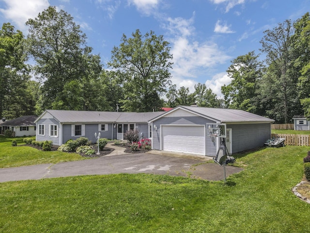 9840 Buckeye Dr, Huntsville, OH 43324 - ranch-style house with asphalt driveway, a garage, and a metal roof