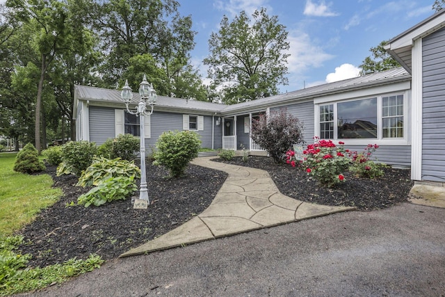 9840 Buckeye Dr, Huntsville, OH 43324 - ranch-style house featuring a metal roof