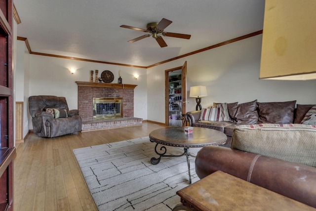 9840 Buckeye Dr, Huntsville, OH 43324 - living room featuring ceiling fan, crown molding, wood-type flooring, and a brick fireplace