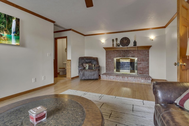 9840 Buckeye Dr, Huntsville, OH 43324 - living room featuring wood finished floors, ornamental molding, a brick fireplace, and ceiling fan