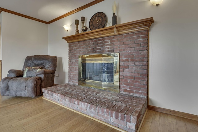 9840 Buckeye Dr, Huntsville, OH 43324 - living area featuring crown molding, hardwood / wood-style floors, and a fireplace