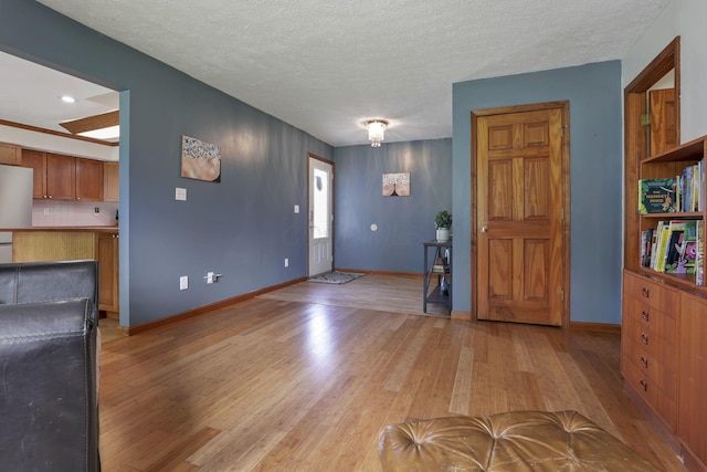 9840 Buckeye Dr, Huntsville, OH 43324 - entryway with light wood finished floors and a textured ceiling