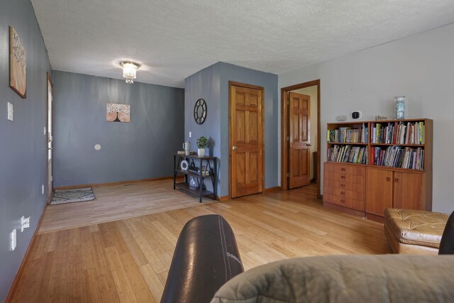 9840 Buckeye Dr, Huntsville, OH 43324 - living area with wood finished floors and a textured ceiling
