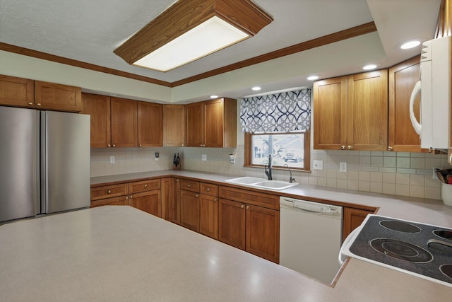 9840 Buckeye Dr, Huntsville, OH 43324 - kitchen with white appliances, light countertops, decorative backsplash, brown cabinets, and ornamental molding