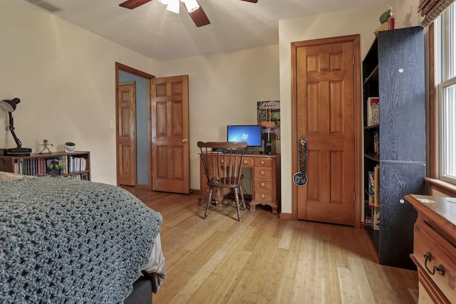 9840 Buckeye Dr, Huntsville, OH 43324 - bedroom featuring light wood-type flooring, multiple windows, and a ceiling fan