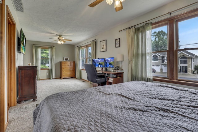 9840 Buckeye Dr, Huntsville, OH 43324 - carpeted bedroom featuring ceiling fan and a textured ceiling