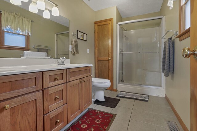 9840 Buckeye Dr, Huntsville, OH 43324 - full bath featuring a stall shower, tile patterned floors, and double vanity