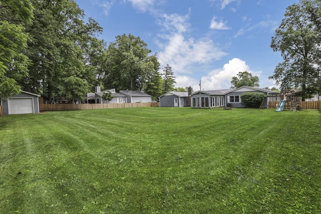 9840 Buckeye Dr, Huntsville, OH 43324 - view of yard featuring a playground and a detached garage