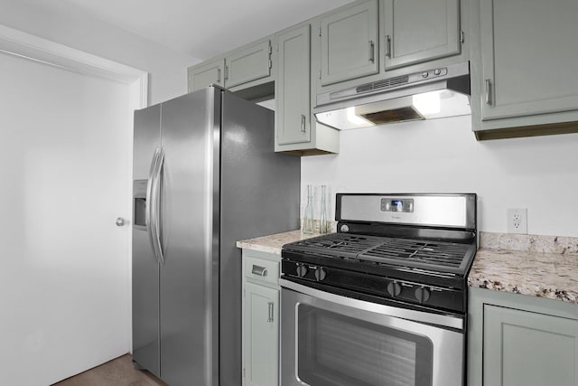 645 E 11th Ave Unit 643, Columbus, OH 43211 - kitchen with stainless steel appliances, under cabinet range hood, wood finished floors, and light stone countertops