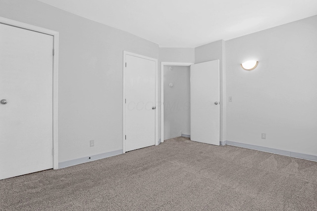 645 E 11th Ave Unit 643, Columbus, OH 43211 - unfurnished bedroom with light carpet and baseboards