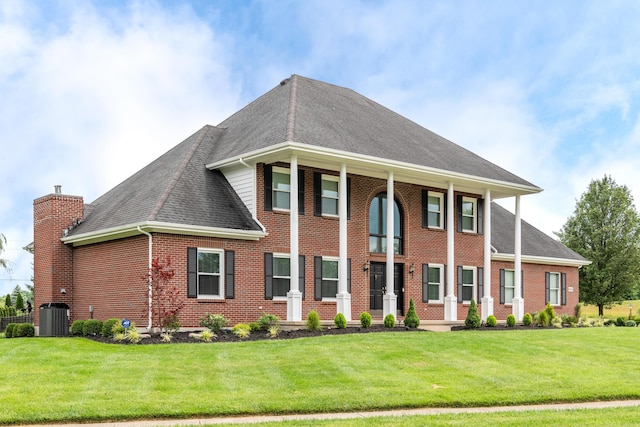 9950 Stonemead Way, Dayton, OH 45458 - view of front of house with a shingled roof, a front lawn, brick siding, and a chimney