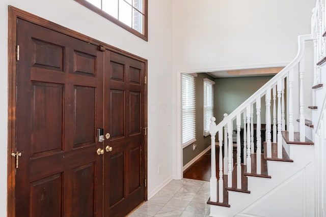 9950 Stonemead Way, Dayton, OH 45458 - foyer with light marble finish flooring, stairs, and a towering ceiling