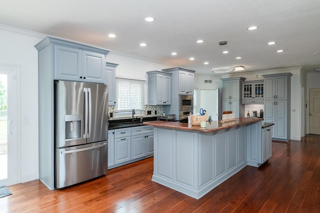 9950 Stonemead Way, Dayton, OH 45458 - kitchen featuring appliances with stainless steel finishes, gray cabinetry, ornamental molding, dark wood-type flooring, and a center island