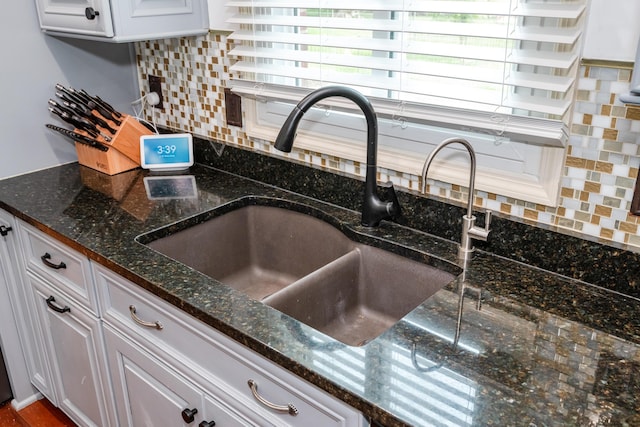 9950 Stonemead Way, Dayton, OH 45458 - kitchen view of white cabinets, tasteful backsplash, and dark stone countertops