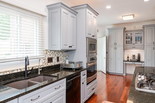 9950 Stonemead Way, Dayton, OH 45458 - kitchen featuring stainless steel appliances, dark wood-style flooring, dark stone counters, gray cabinets, and tasteful backsplash