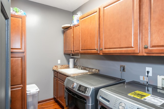 9950 Stonemead Way, Dayton, OH 45458 - laundry area with washer and dryer, cabinet space, and wood finished floors