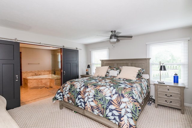 9950 Stonemead Way, Dayton, OH 45458 - bedroom with a barn door, ensuite bathroom, and a ceiling fan