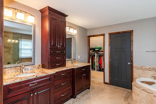 9950 Stonemead Way, Dayton, OH 45458 - full bathroom featuring double vanity, tile patterned flooring, a bath, and a spacious closet