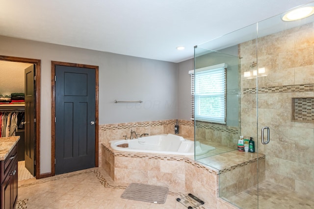 9950 Stonemead Way, Dayton, OH 45458 - full bathroom featuring a bath, a stall shower, vanity, tile patterned floors, and a walk in closet