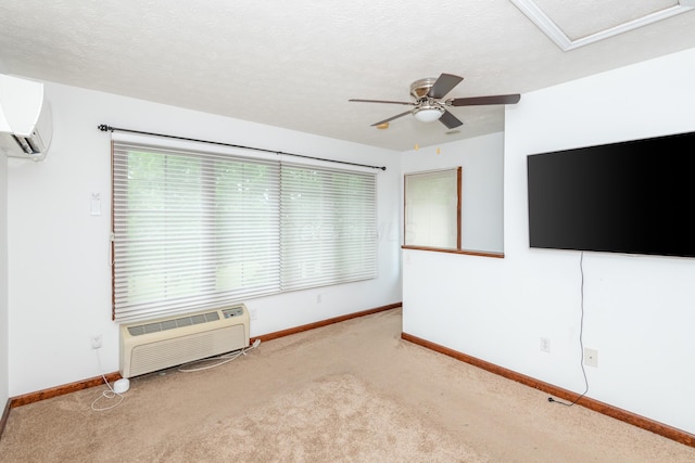 9950 Stonemead Way, Dayton, OH 45458 - unfurnished room featuring a wall mounted air conditioner, carpet flooring, a ceiling fan, a textured ceiling, and attic access