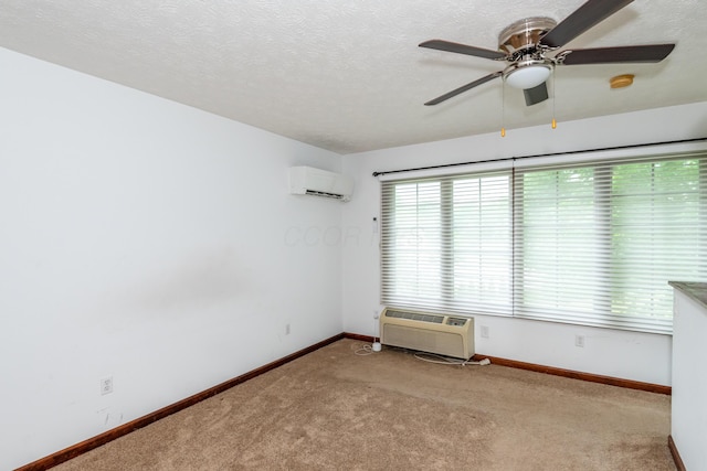 9950 Stonemead Way, Dayton, OH 45458 - spare room featuring a wall unit AC, carpet flooring, ceiling fan, a smoke detector, and a textured ceiling