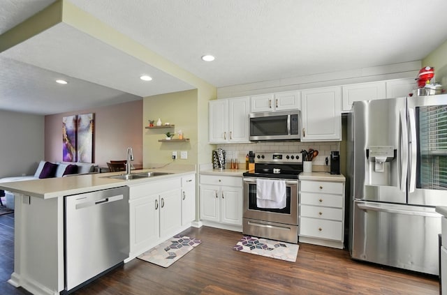 5346 Calypso Cascades Dr, Dublin, OH 43016 - kitchen featuring stainless steel appliances, a peninsula, light countertops, recessed lighting, and dark wood-style floors