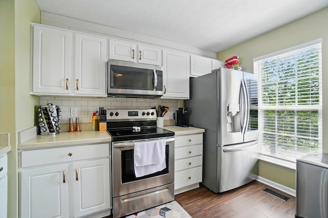 5346 Calypso Cascades Dr, Dublin, OH 43016 - kitchen featuring stainless steel appliances, white cabinetry, and decorative backsplash