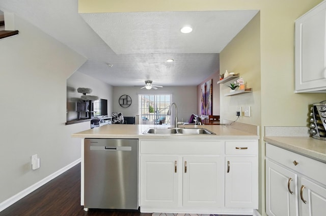 5346 Calypso Cascades Dr, Dublin, OH 43016 - kitchen with stainless steel dishwasher, a ceiling fan, a peninsula, dark wood finished floors, and light countertops