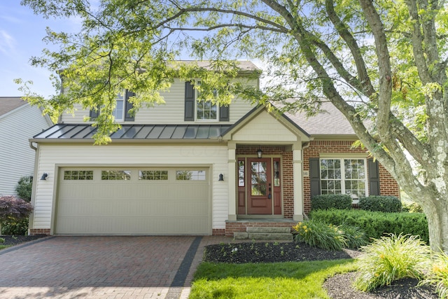 7341 Clancy Way, Westerville, OH 43082 - view of front of house featuring a standing seam roof, decorative driveway, a garage, and a metal roof
