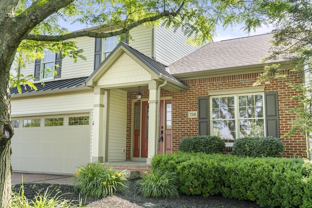 7341 Clancy Way, Westerville, OH 43082 - view of front facade with an attached garage, brick siding, and a standing seam roof