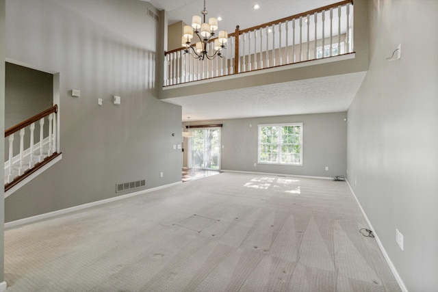 7341 Clancy Way, Westerville, OH 43082 - unfurnished living room with a high ceiling, a chandelier, stairs, and carpet flooring