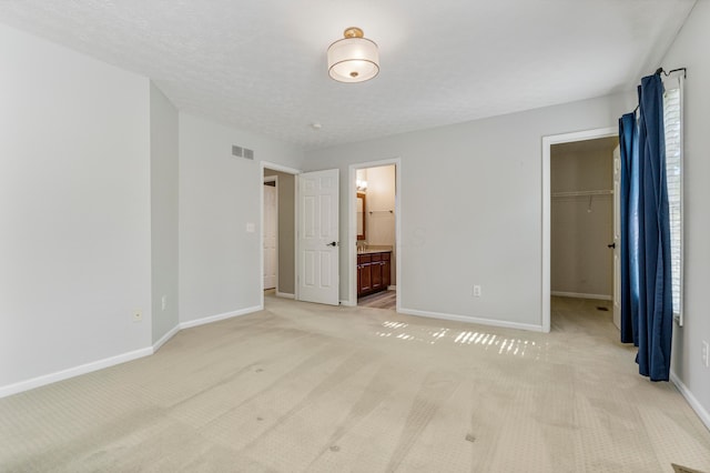 7341 Clancy Way, Westerville, OH 43082 - unfurnished bedroom with light colored carpet, a walk in closet, connected bathroom, and a closet