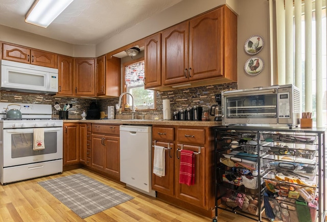 1845 N Columbus St, Lancaster, OH 43130 - kitchen featuring white appliances, brown cabinets, and tasteful backsplash