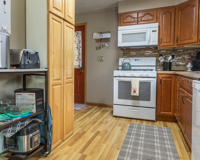 1845 N Columbus St, Lancaster, OH 43130 - kitchen with white appliances, light wood-style flooring, light countertops, brown cabinets, and crown molding