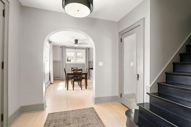 405 N Union St, Galion, OH 44833 - foyer with arched walkways, light wood-type flooring, stairs, and ceiling fan