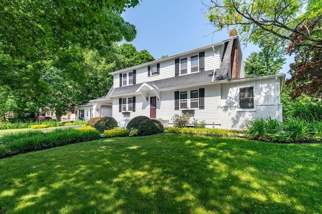 405 N Union St, Galion, OH 44833 - view of front of home with a front lawn, a chimney, and an attached garage