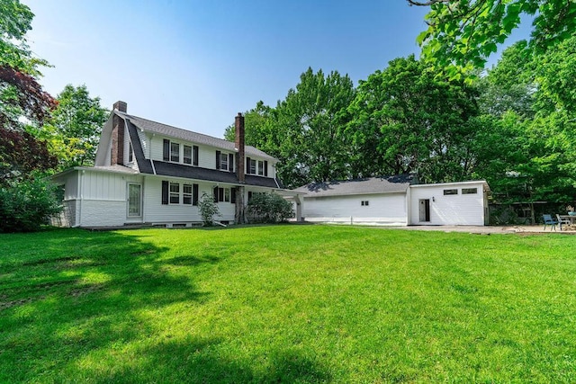 405 N Union St, Galion, OH 44833 - rear view of property with a chimney, a lawn, and board and batten siding