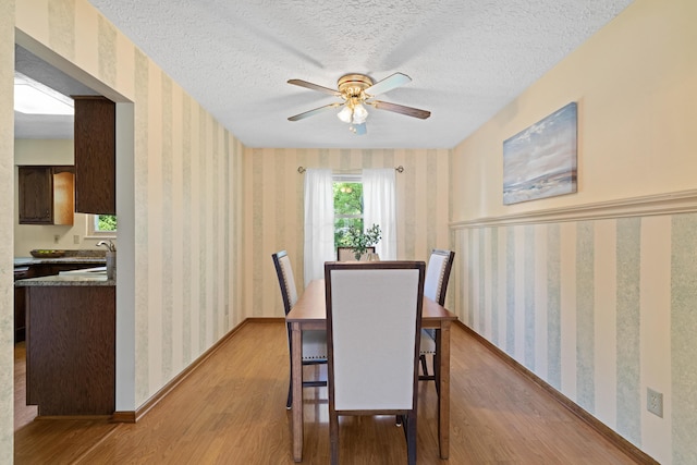 9 Intermeadows Way, Powell, OH 43065 - dining area featuring wallpapered walls, light wood finished floors, ceiling fan, and a textured ceiling